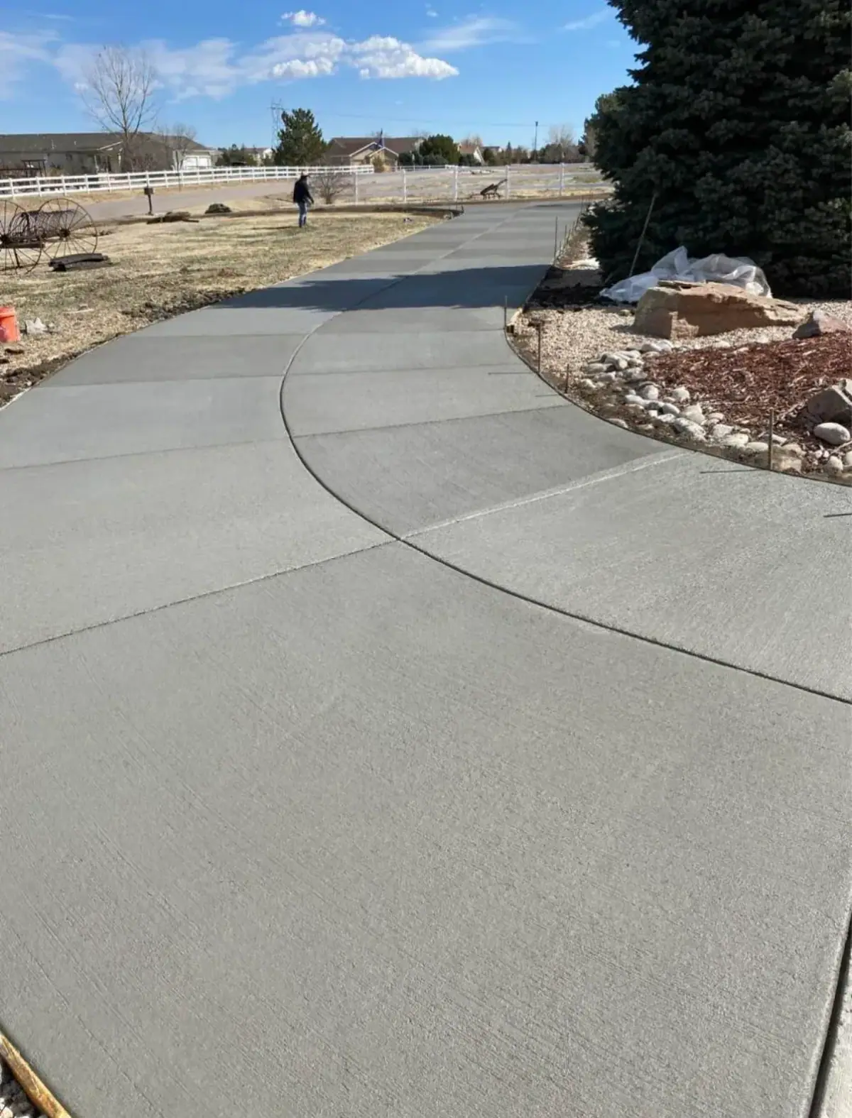 Curved driveway beside a white rail fence, A & M Contracting